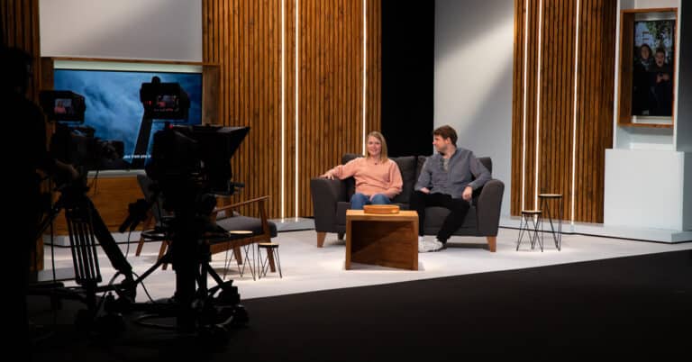 The hosts of Open Doors sit on set together, facing camera.