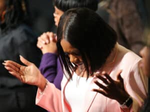 lady bowing her head in prayer