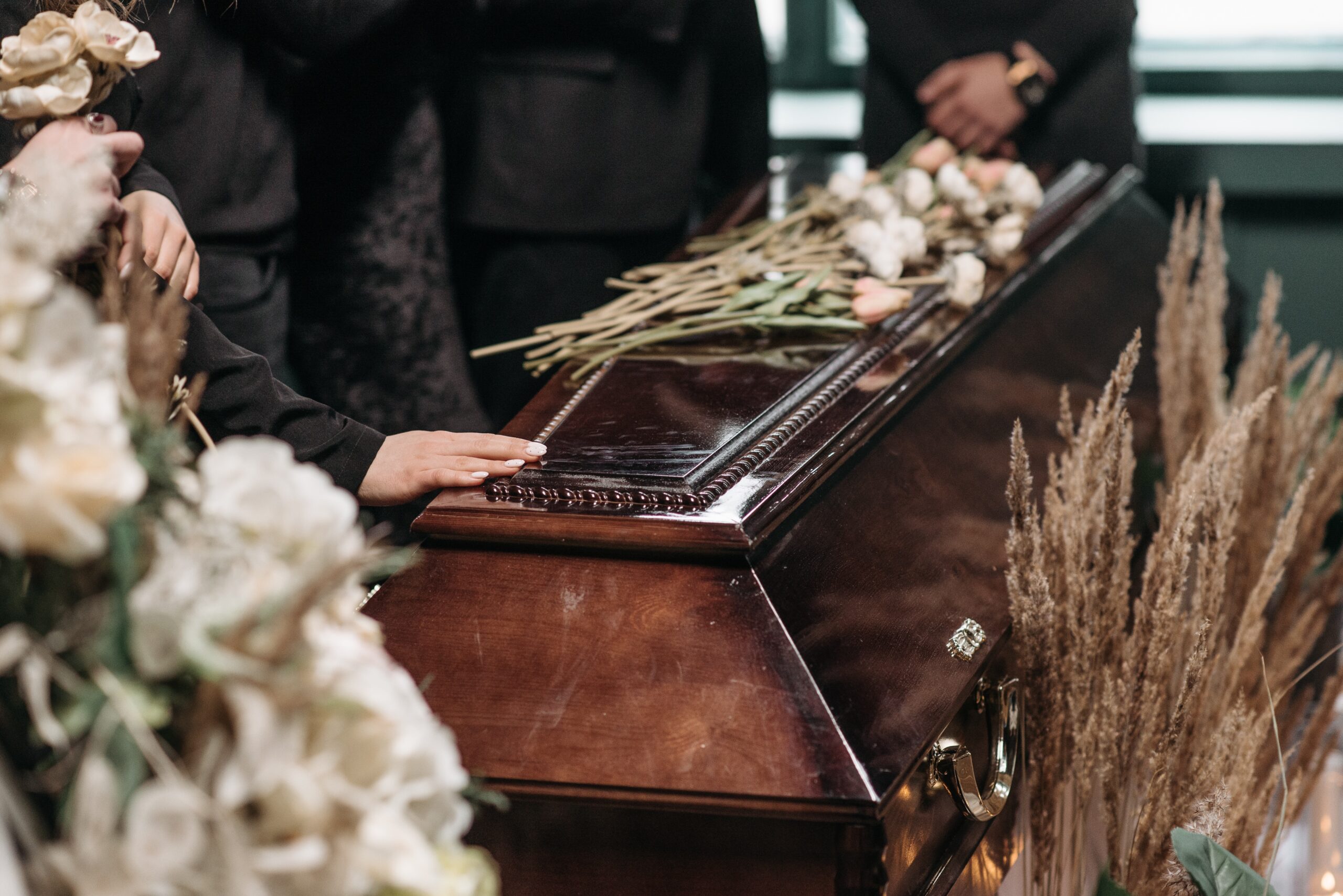 coffin with flowers on top