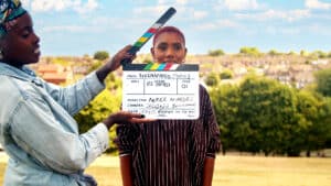 woman with a clapperboard - filming on location