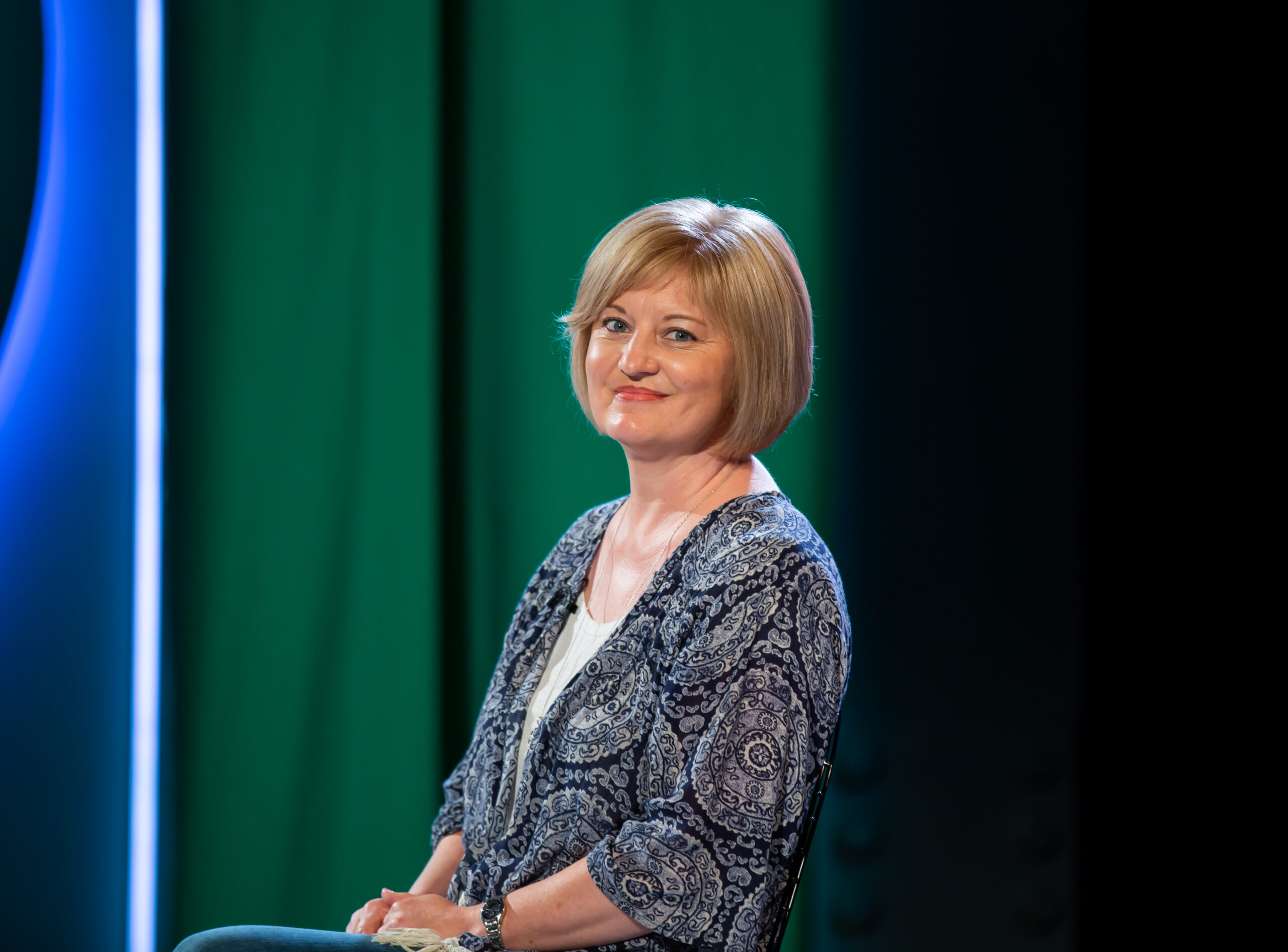 Angela Colyer sitting on the set of Awakening