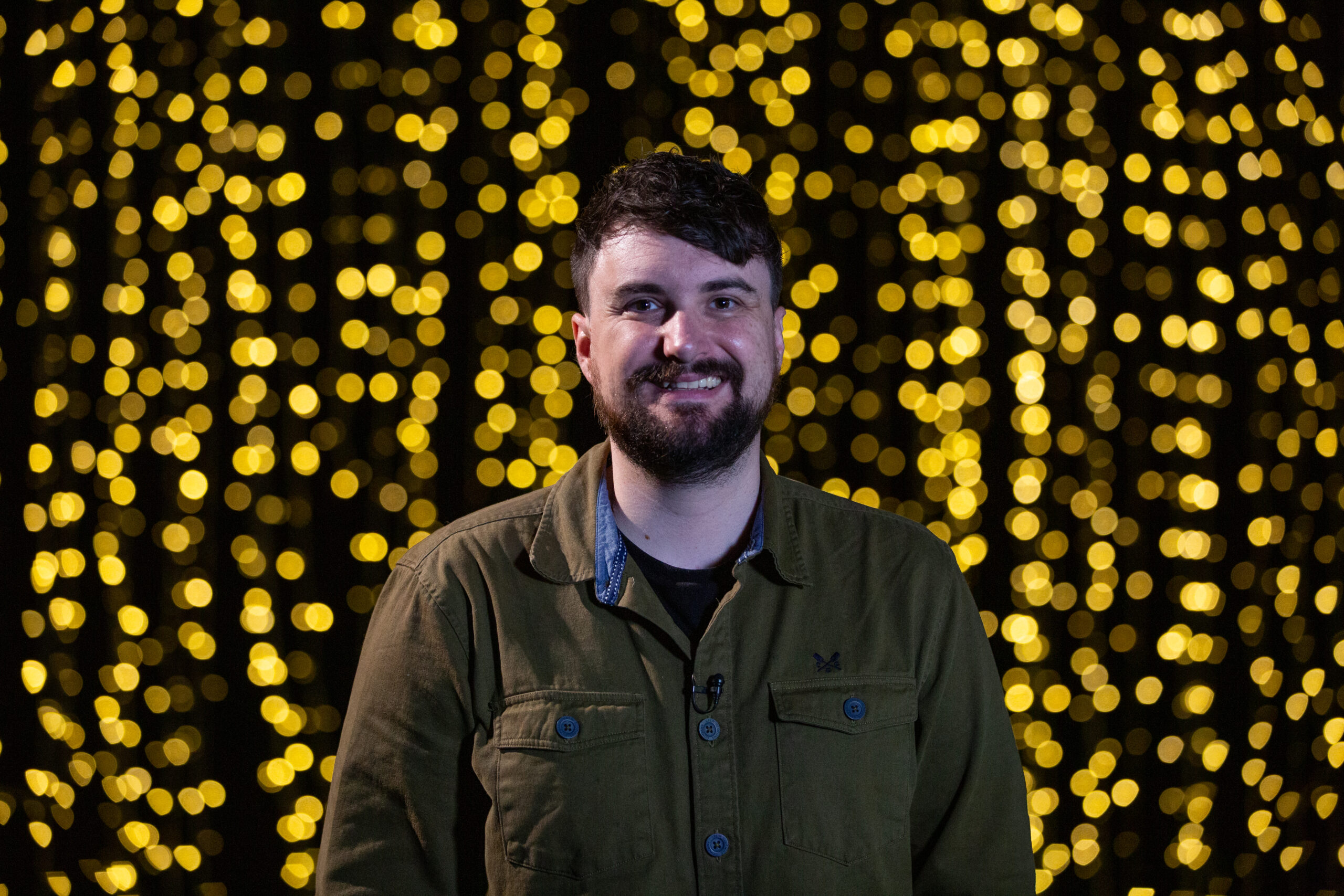 Dai Woolridge in front of a curtain of lights