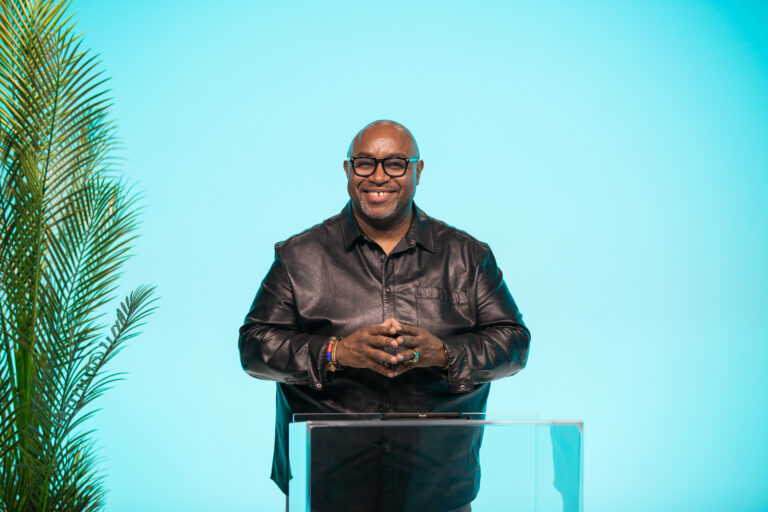 Bishop Wayne Malcolm behind a lectern