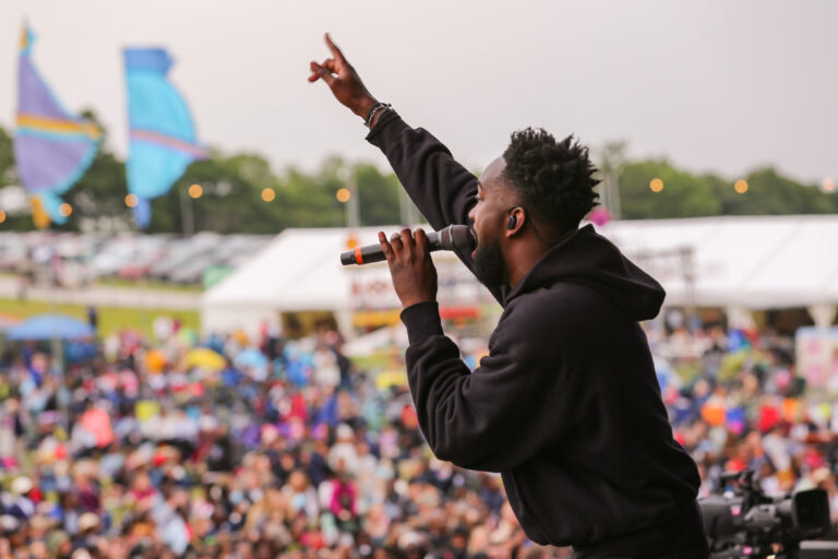 man on stage at big church festival