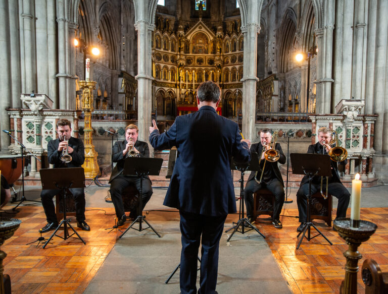 Simon Lole conducting the orchestra in church