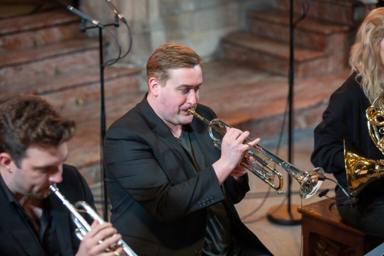 man playing the trumpet in church