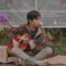 man busking with a guitar