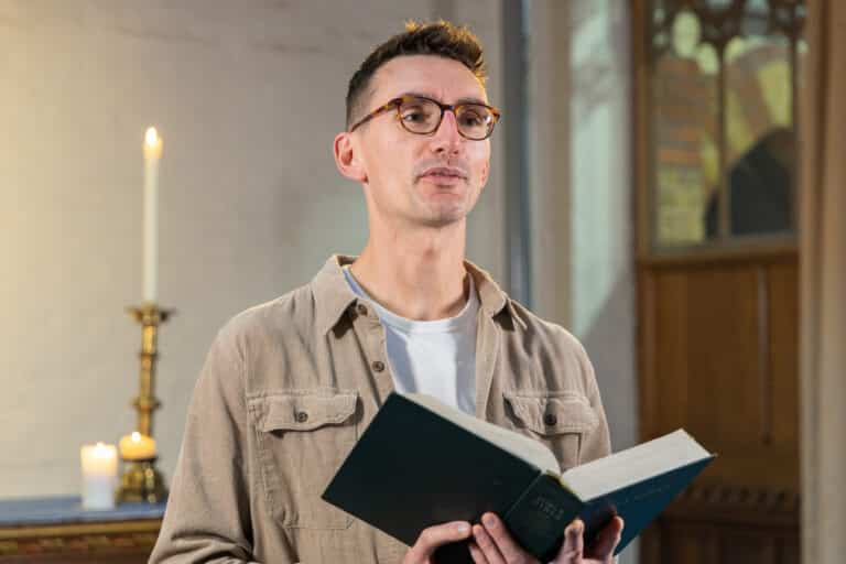 Man giving a bible reading for Mercy Ships Christmas Carols