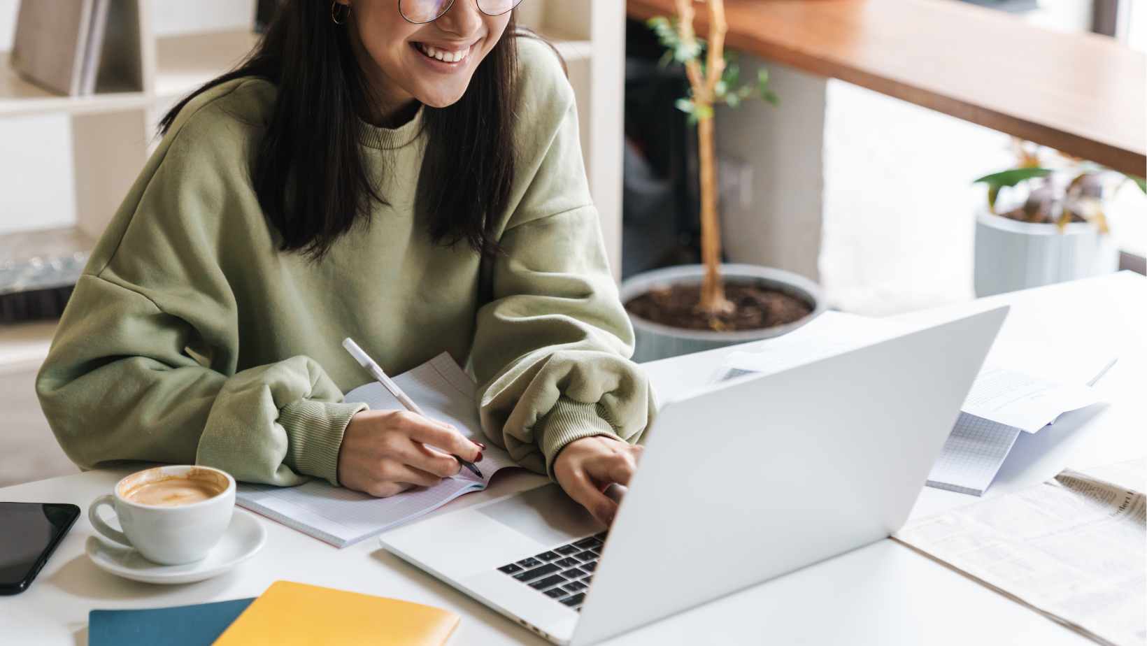 Woman at her laptop with a cup of coffee