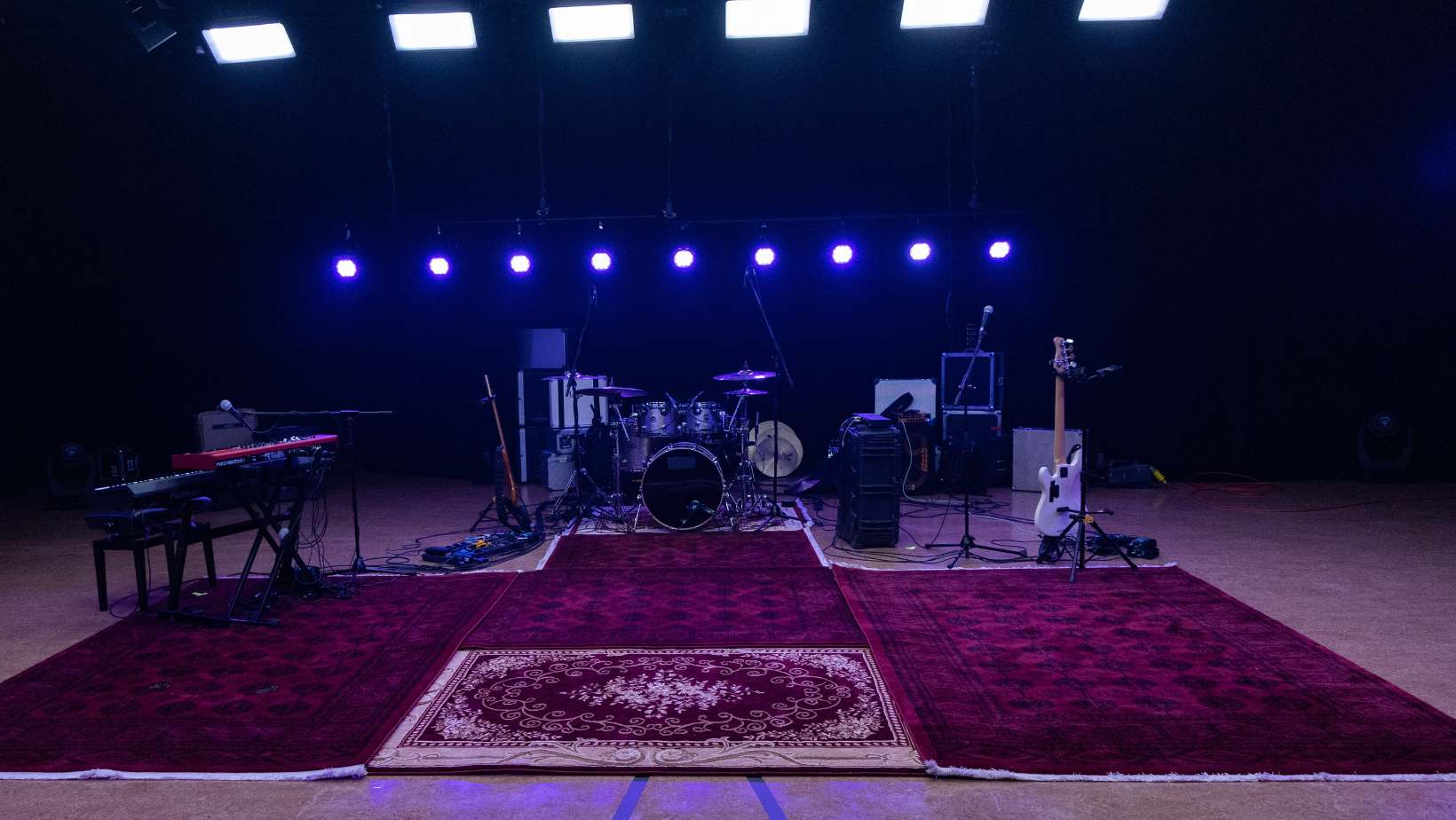 Studio set up for a band with drums and guitar and keyboard