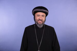 Archbishop Angaelos in front of blue background