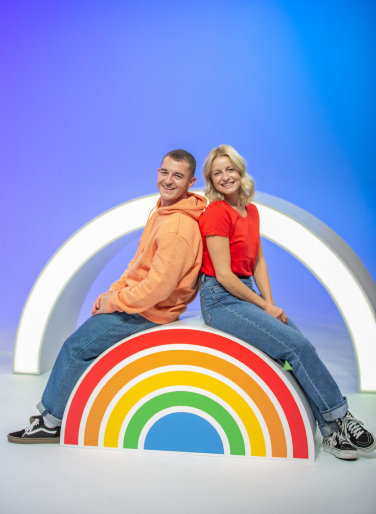 Mega Mix, Alex and Rachel sitting on a rainbow